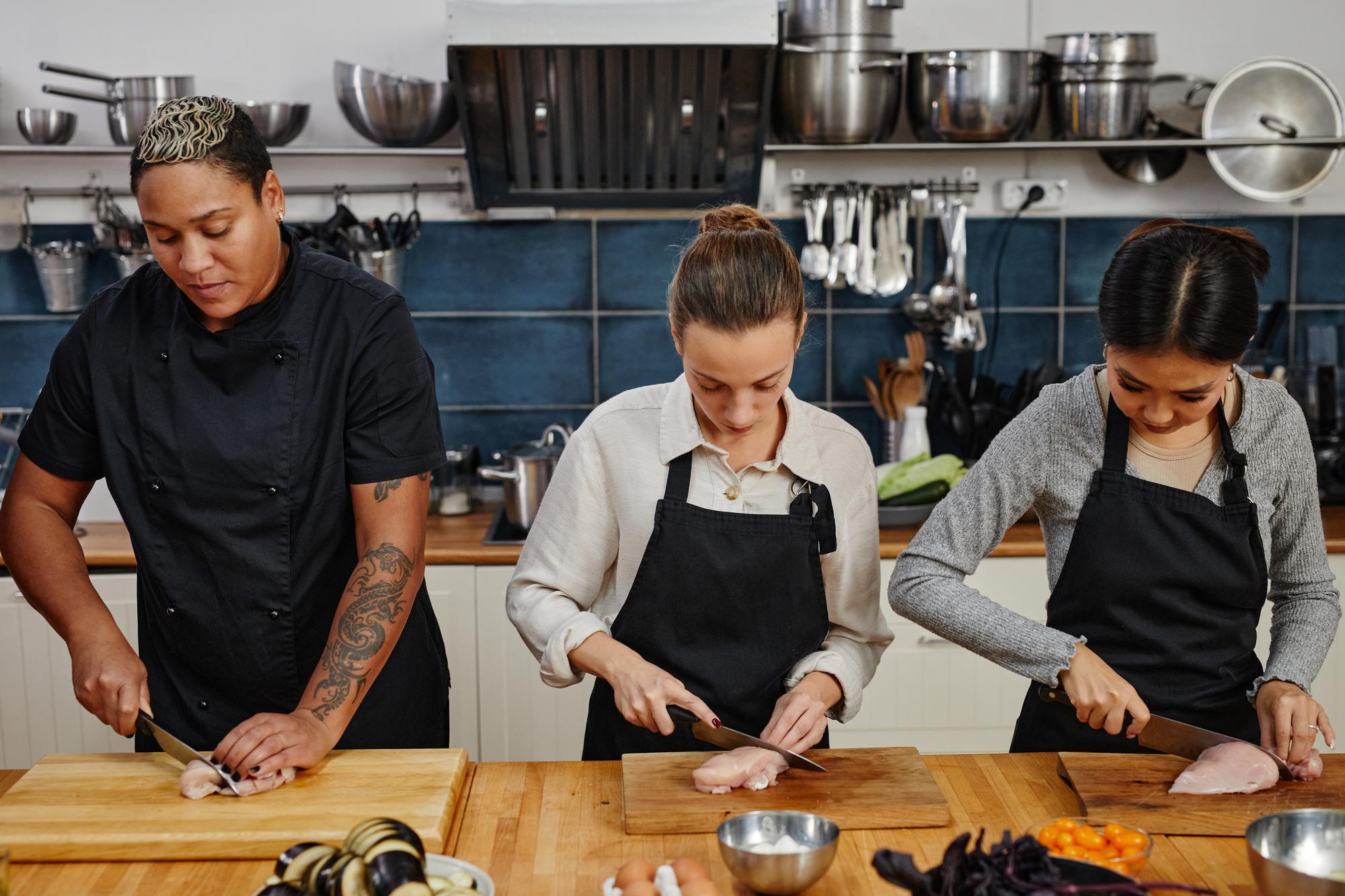 Students learning knife skills in studio class